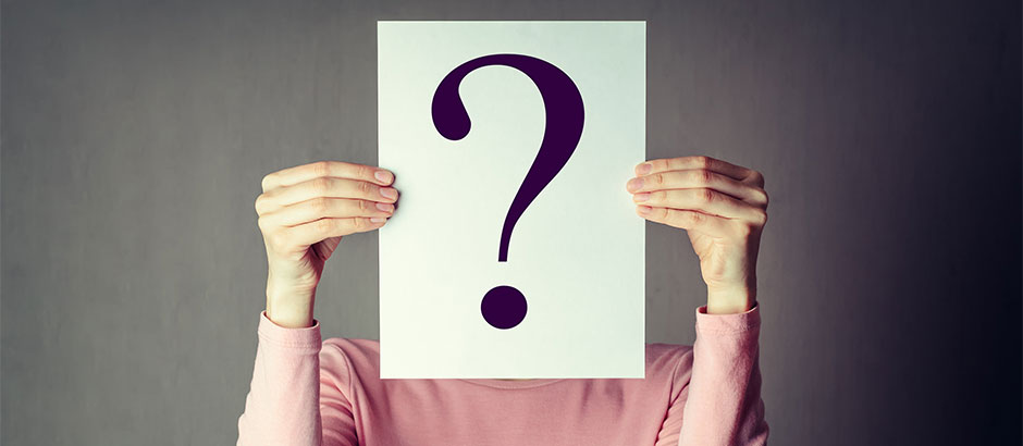 Frau mit Blatt mit Fragezeichen vorm Gesicht. Symbolisch für Help Desk